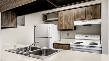 A kitchen with white appliances and a sink